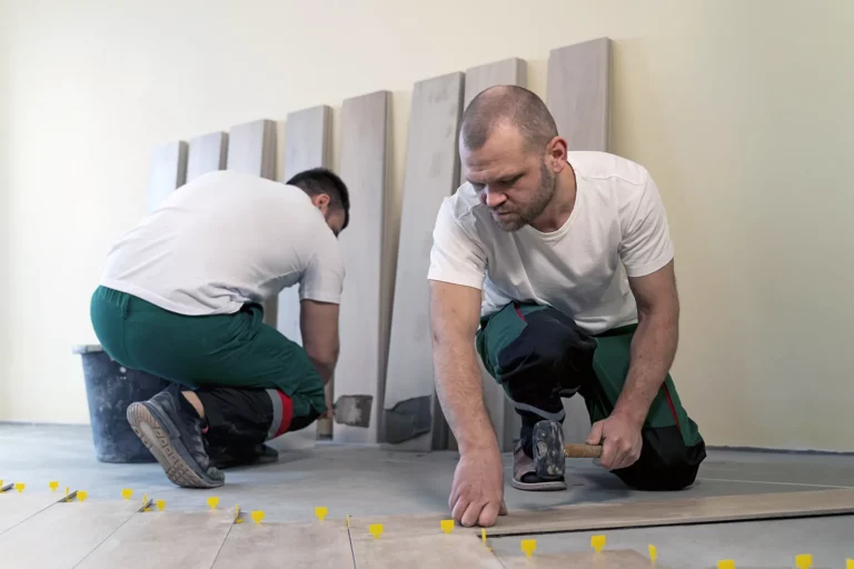 close-up photo of a worker laying parquet in Batumi