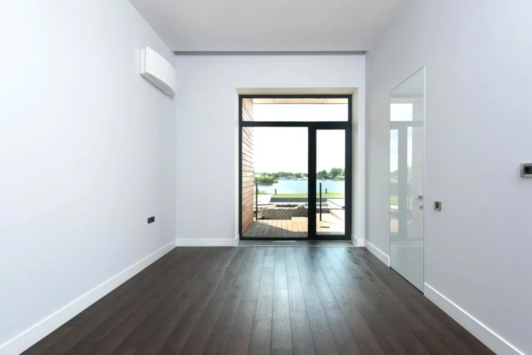 The room is renovated with green framing and laminate flooring