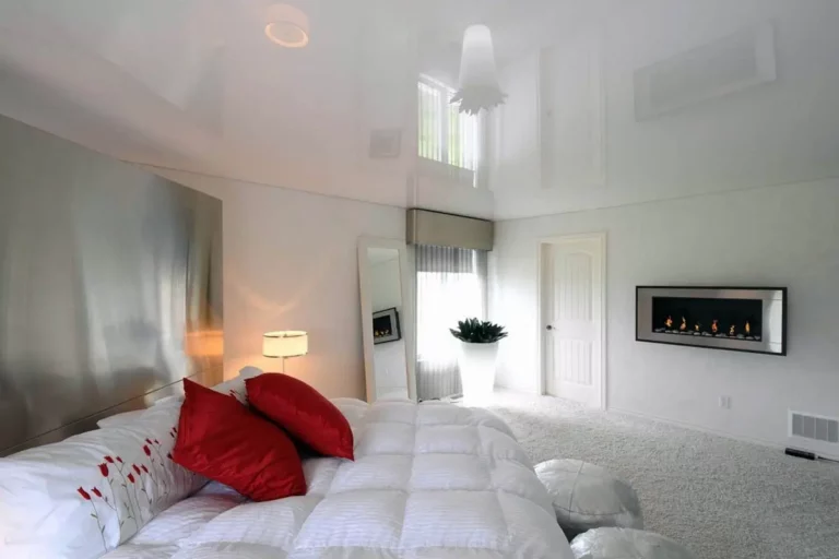 bedroom with a large bed and white glossy stretch ceiling