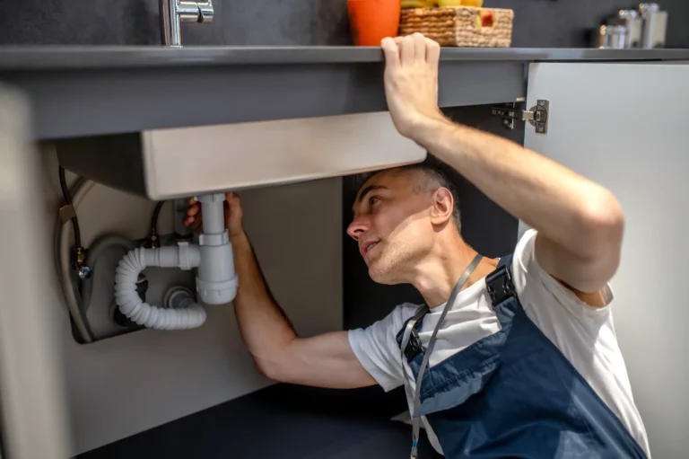 Plumber installs a siphon